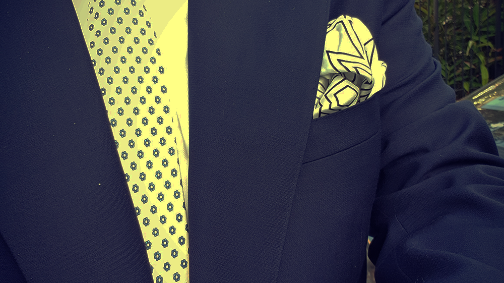A Cream Tie On A Navy Suit Is Super Elegant