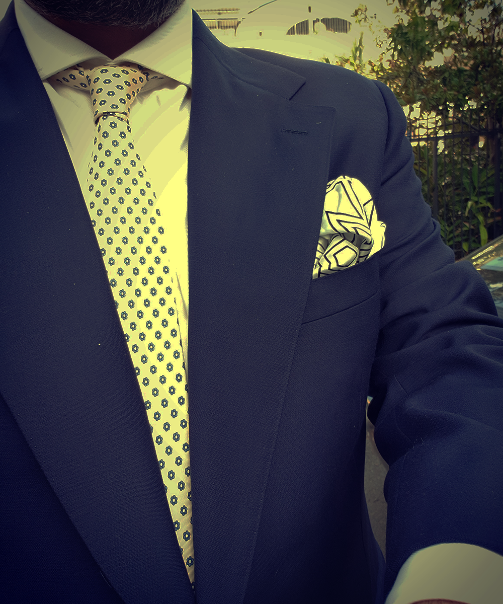 A Cream Tie On A Navy Suit Is Super Elegant